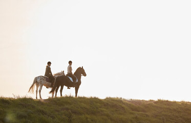 Horse riding provides such a sense of escapism and relaxation. Shot of two young women out horseback riding together.