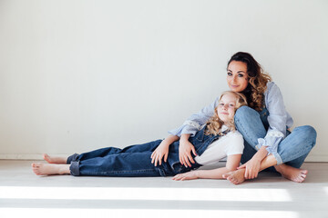 mother and daughter together play motherhood on a white background