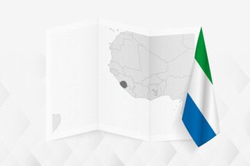 A grayscale map of Sierra Leone with a hanging Sierra Leonean flag on one side. Vector map for many types of news.