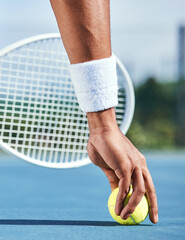 Another game is in order. Cropped shot of an unrecognisable man picking up a tennis ball during...