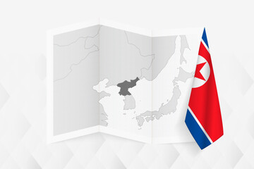 A grayscale map of North Korea with a hanging North Korean flag on one side. Vector map for many types of news.