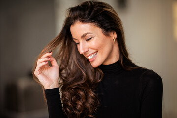 Portrait of an attractive brunette haired woman with toothy smile - 596308659