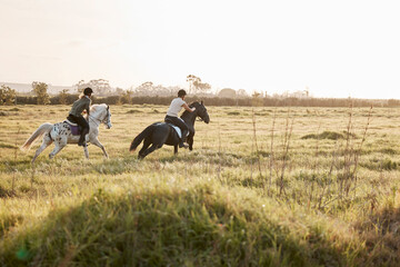 Fototapeta premium You go at your own pace. Shot of two young women out horseback riding together.