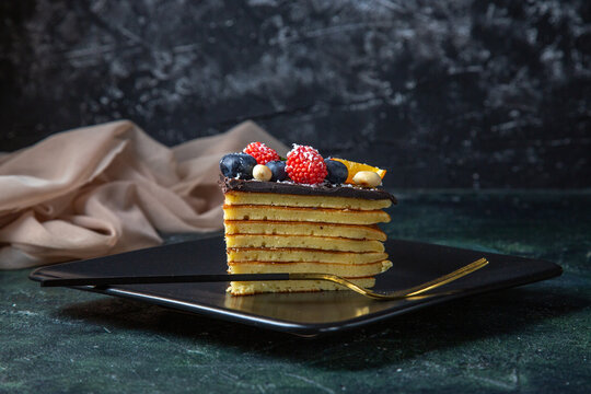 front view cake slice delicious chocolate cake with fruits inside plate on dark background pie dough biscuit sugar sweet dessert tea cakes