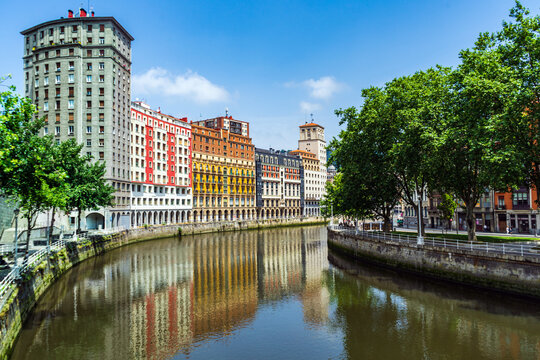 High Bright multi colored houses apartment buildings along the Nervion River, Bilbao, Spain. Colorful architecture.