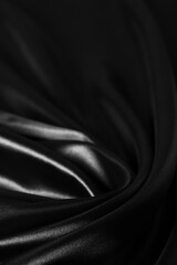 Obraz premium Background black twisted silk fabric,abstract texture satin fabric.