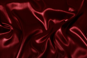 Silk fabric, abstract wavy red satin fabric background.