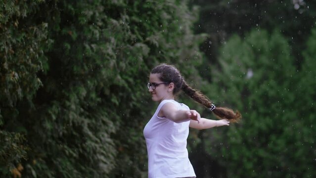 Joyful Rain Dance: Happy Girl Celebrating in Slow Motion