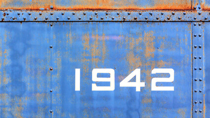 Grunge worn rusty metal background with chipped and faded painted numbers