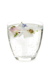 Glass of sparkling water with ice , decorated with flowers