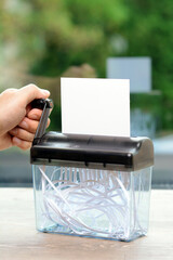 Shredder with empty sheet of paper with copy space is shredded
- 596316692