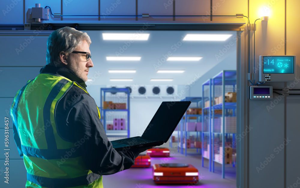 Poster man is storekeeper. worker with laptop. robotic freezer. autonomous storage carts. warehouse refrige