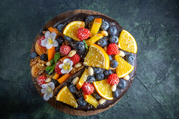 top view delicious fruit cake with chocolate syrup on round wooden desk dark background tea pie...