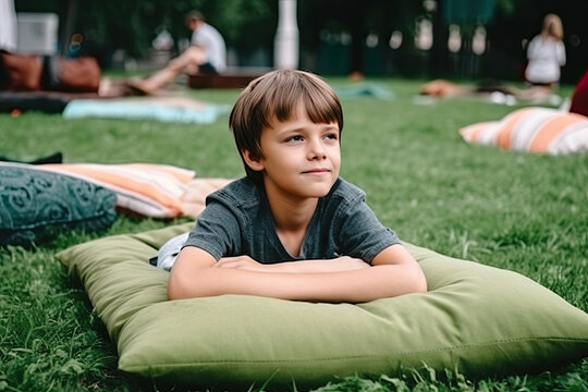 Resting boy lies on big cozy pillow on the grass in the park, created with Generative AI