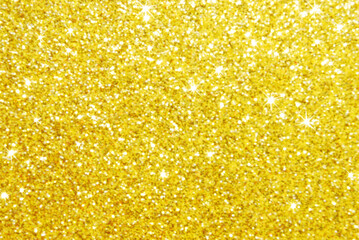 Golden defocused glitter texture as background
