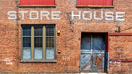 Warehouse brick front background  with Store House stenciled above door