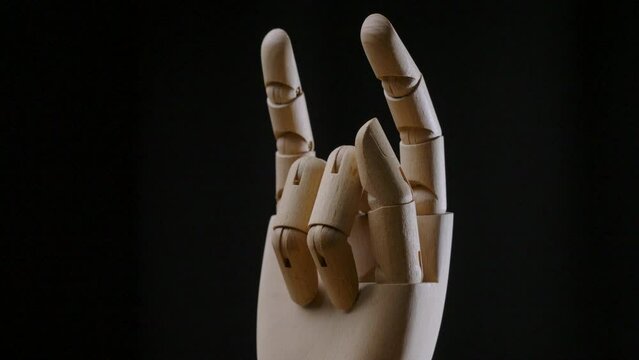 the rock music hand symbol of wooden robot