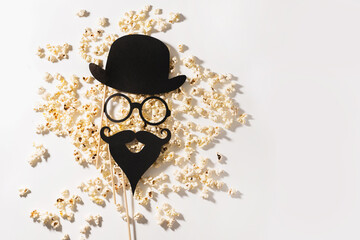 Scattered delicious popcorn and photo booth prop for movie party