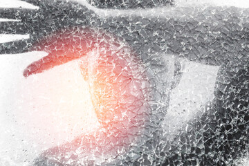 Man behind wet and cracked glass. Concepts of mental disorder or other social issues affecting...