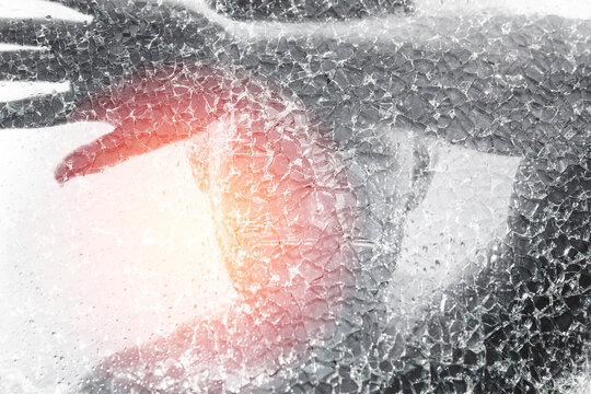 Man behind wet and cracked glass. Concepts of mental disorder or other social issues affecting human personality