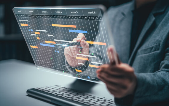 Planning and Implementation, Business people use laptop computers to manage work projects and update tasks. Work progress, efficient scheduling.Business Data Management scheduling interface