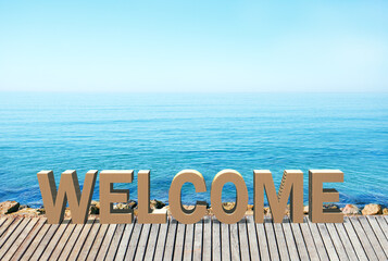 Word Welcome on seaside promenade. Summer vacation concept.