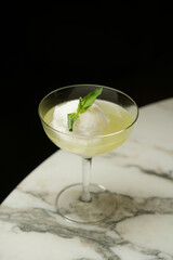 Cocktail glass with ice cream and mint leaf