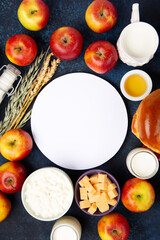 Jewish Shavuot Holiday Card. Dairy Products, Apples, Cheese, Bread, Milk on Blue Wooden Background.