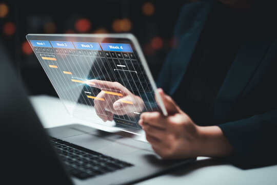 Planning and Implementation, Business people use laptop computers to manage work projects and update tasks. Work progress, efficient scheduling.Business Data Management scheduling interface