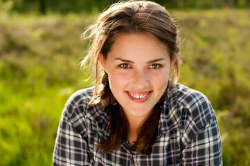 Fototapeta premium A fresh face in nature. Shot of a beautiful young woman relaxing in the park outside.