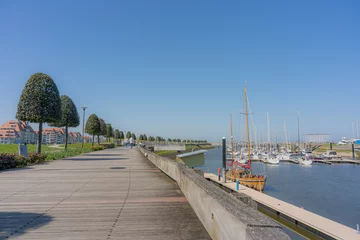 Foto op Canvas Walking route in Nieuwpoort along 1 of the largest marinas in Europe with a view of the North Sea and the harbour.  There is a large wide renewed path for both cyclists and walkers. © robin