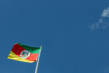 Rio Grande do Sul state flag waving in the wind in a sunny day. Blue sky background