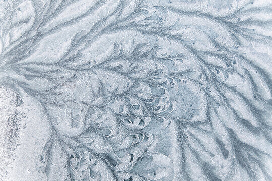 Abstract ice textures on car window in winter