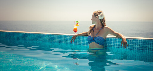 Fototapeta premium Woman relaxing at the pool