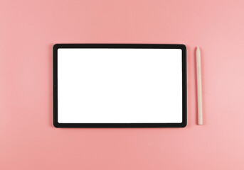 flat lay of digital tablet with blank white screen and pink stylus pen isolated on pink background.