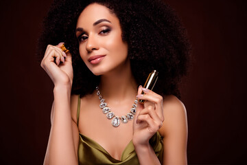 Photo of happy chic classy lady look mirror applying mascara for large smoky eyelashes on dark color background