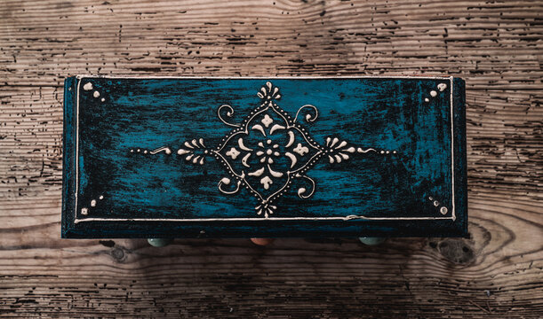 Ornamental box placed on wood background
