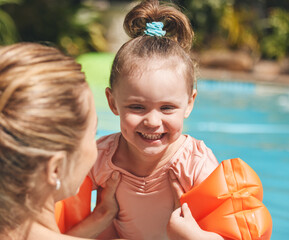 She loves the water. Cropped shot of an adorable little learning to swim with her mother.