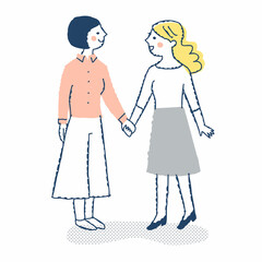 見つめ合って手を繋ぐ若い女性2人
