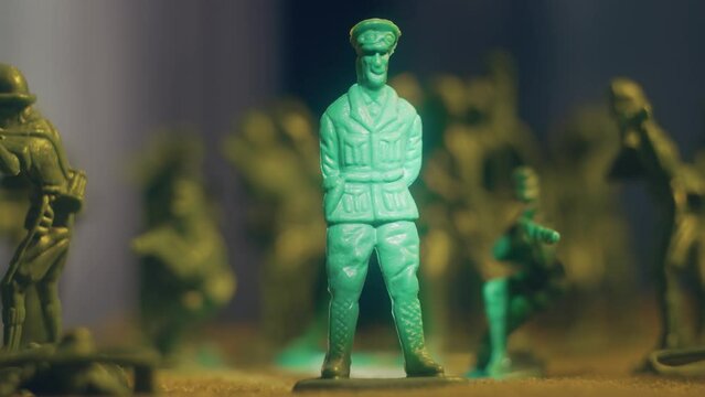 Assassination of army general surrounded by toy soldiers, immitation murder main trooper. Violence war resistance and peace without armored invasion