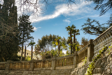 View at a mediterrean garden with palm trees along the promenade in Opatija, Istria, Croatia, in early spring outdoors