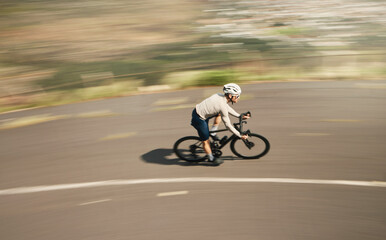 Ripping up the road. High angle shot of a handsome mature man cycling outdoors.