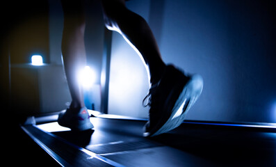 silhouette of a leg in a gym  training on treadmill.