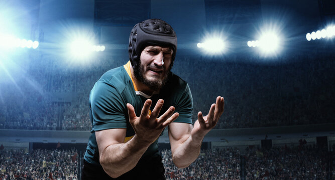 Loosing game. Man, professional rugby player in uniform standing despair and sadness at 3D stadium with flashlights. Concept of sport, competition, game, emotions - Powered by Adobe