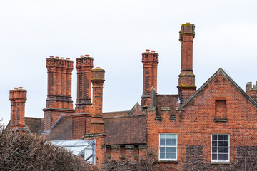 HAMPTON COURT, UK: 2013 CIRCA MARCH 2023: Chimney stacks above rooms at the Hampton Court Palace...