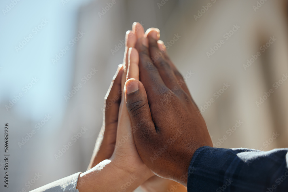 Poster a supportive team. shot of a group of unrecognizable businesspeople giving each other a high five in