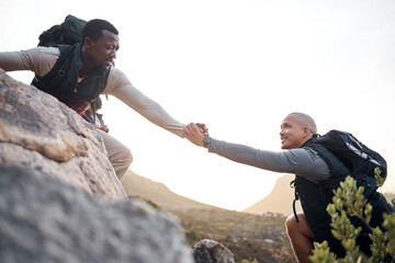 We go further when we work together. Cropped shot of a handsome young man helping his friend along...