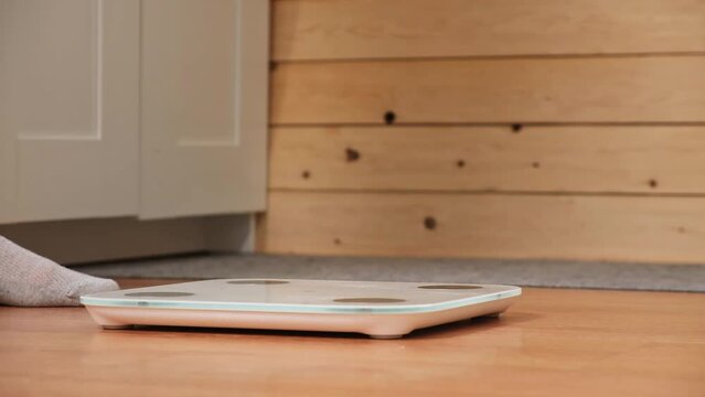 A man stands on the scales. The guy is weighing himself. Floor scales for health. Weight control.