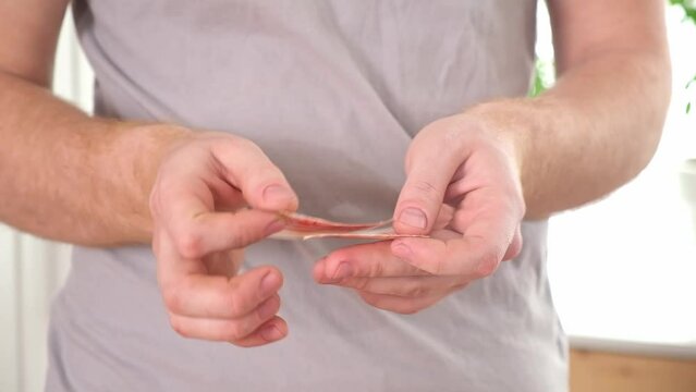 A man tears up Russian 5000 rubles. Crisis, inflation, depreciation of money.