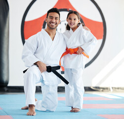 No matter how small, always stand tall. Shot of a young man and cute little girl practicing karate in a studio. © Siphosethu Fanti/peopleimages.com